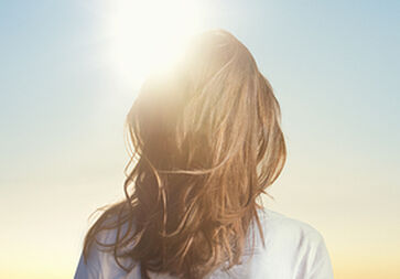 woman standing in the sun